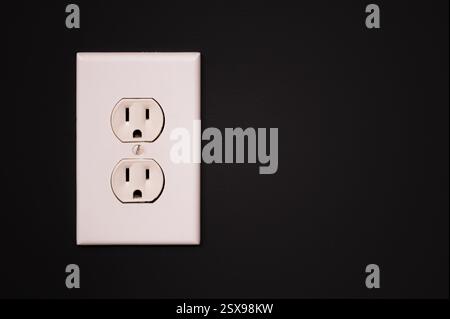 White duplex outlet on a slate gray wall with copy space Stock Photo