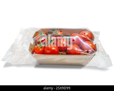 Tomatoes in cardboard tray packed in clear plastic bag isolated on white with clipping path included Stock Photo