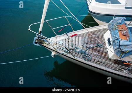 Deck of sailing yacht with wooden decking and ropes, Padstow Harbour, Cornwall, UK Stock Photo