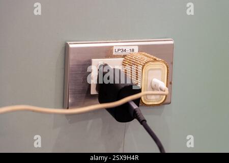 Electrical outlet with mobile device adapters connected Stock Photo