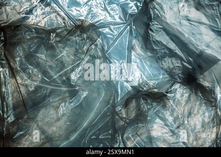Texture of glossy polyethylene plastic sheet material crumpled and wrinkled from above Stock Photo