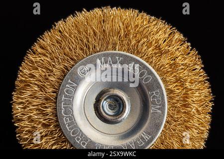 Wire brush for drill for cleaning parts. Macro photography on dark background Stock Photo