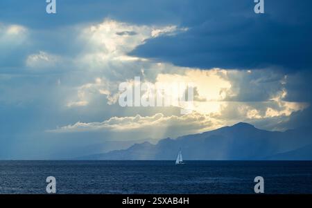 Sun rays in the clouds over Sicily, Tyrrhenian Sea, Italy Stock Photo