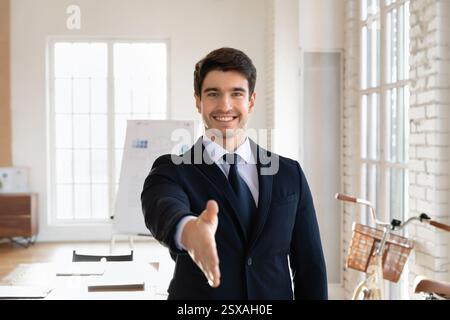 Portrait of professional man in suit extending hand for handshake Stock Photo