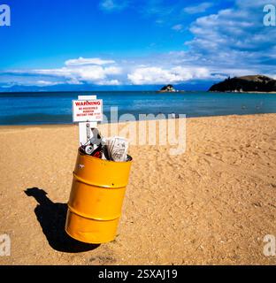 Trash can on beach Stock Photo