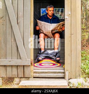 Man reading on loo Stock Photo