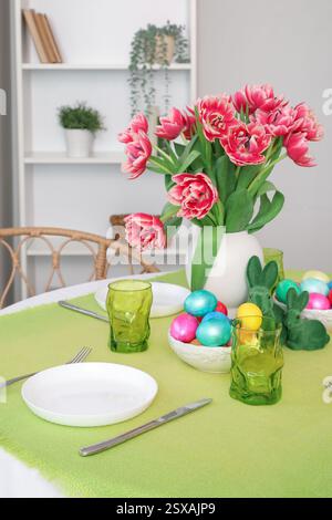 Beautiful table serving with red tulips for Easter celebration Stock Photo