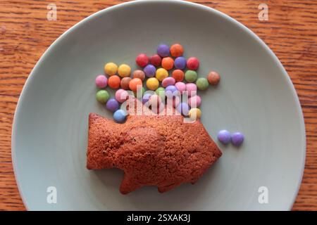 homemade baked Easter and Christmas tree-shaped muffin with colorful candies Stock Photo