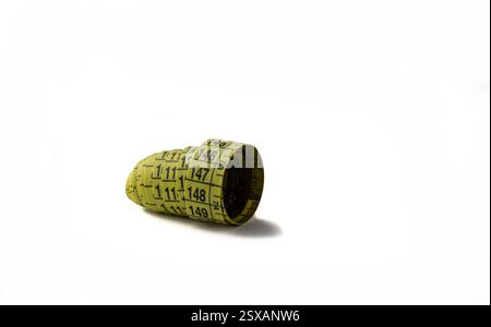 Tailor's measuring tape in a roll on a white background. Stock Photo