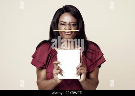 Funny african american young woman student holding notepad Stock Photo