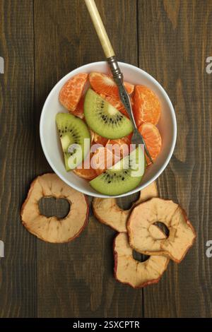 Clementine pieces and kiwi slices in peel, dried apple slices Stock Photo