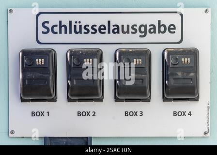 Key distribution boxes, safes, at a small hotel, guests receive a code with which they can open the boxes and remove the room key when reception is cl Stock Photo