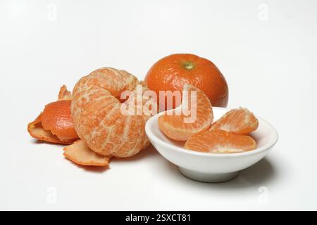 Peeled clementine, clementine and clementine pieces Stock Photo