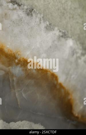 Close-up of marble showing a distinct orange vein and gray texture, stone, natural stone, stone structure Stock Photo