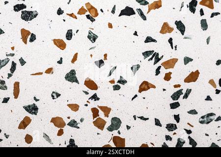 White terrazzo surface with green and brown speckles forming a distinct pattern, stone, natural stone, stone structure Stock Photo