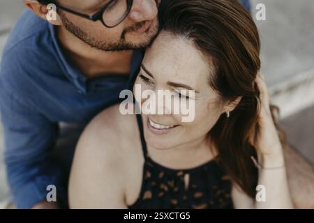 Couple portrait, couple sitting together on stone steps Stock Photo
