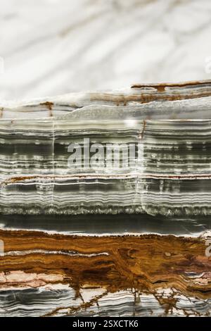 Cross-section of variegated marble showcasing gray, brown, and white layers and textures, stone, natural stone, stone structure Stock Photo