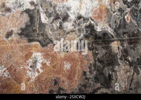 Multicolored marble with intricate orange and black patterns and smooth texture, stone, natural stone, stone structure Stock Photo