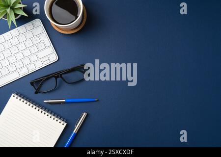 Workspace with keyboard, office supplies, pen, green leaf and coffee cup. Flat lay, top view blue office desk Stock Photo