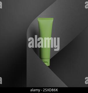 Green cosmetic tube mockup is elegantly presented against a black folded paper background Stock Photo