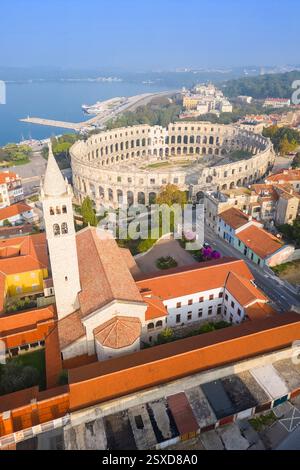 View of the St. Anthony Church and Pula Arena at sunrise. Pula, Istria, Croatia. Stock Photo