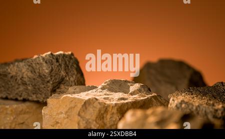 Natural stone podium with warm lighting, rugged stone texture, earthy tones, ideal for product placement, rocky surface, textured stones, warm orange Stock Photo