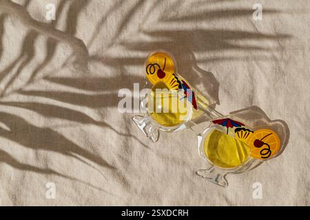 Summer scene with party sunglasses and tropical palm tree leaf shadow on sand color linen background. Sun and shadows. Minimal concept. Stock Photo