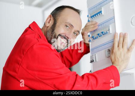 electrician installing energy saving meter Stock Photo