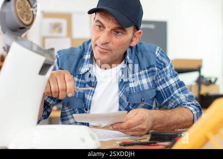 professional worker fixing coffee machine Stock Photo