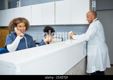 Healthcare Professionals Collaborating at a Modern Office Front Desk in a Clinical Setting Stock Photo