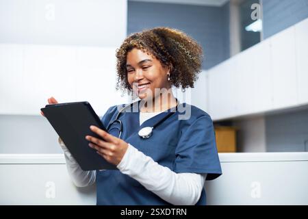 Smiling Healthcare Professional Using Digital Tablet in Modern Office Stock Photo