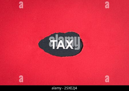 Tax on a ripped torn red paper with black background. Copy space. Stock Photo