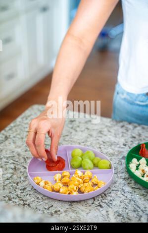 Mom Preparing After-School Snack in Kitchen for Kids Stock Photo