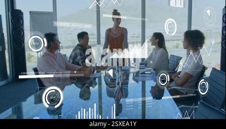 Image of data processing over diverse colleagues having meeting in office Stock Photo