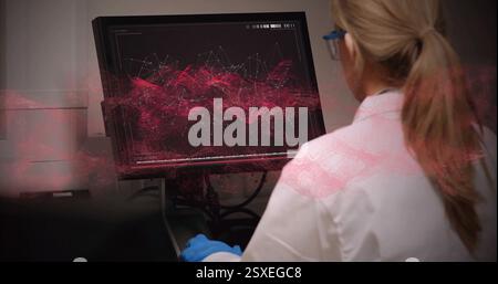 Image of data processing over caucasian female scientist using computer in laboratory Stock Photo