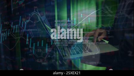 Image of financial data processing over african american businessman using laptop in server room Stock Photo