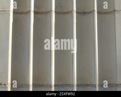 striped solid volumetric background of gray concrete color, fragment of exterior of street structure, external detail of building close-up stripe Stock Photo