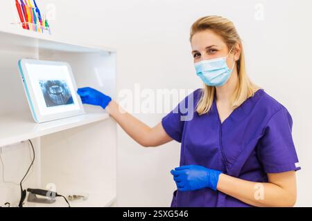 Dentist is examining x-ray image of jaw and teeth. Stock Photo