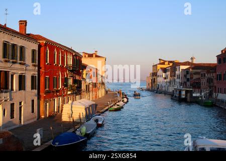 Vibrant and colourful views at sunrise over the Venetian lagoon, in Venice, Italy, during a winter visit Stock Photo