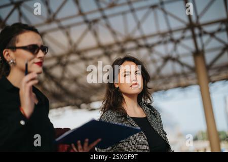 Multicultural business team discussing growth and strategy outdoors Stock Photo