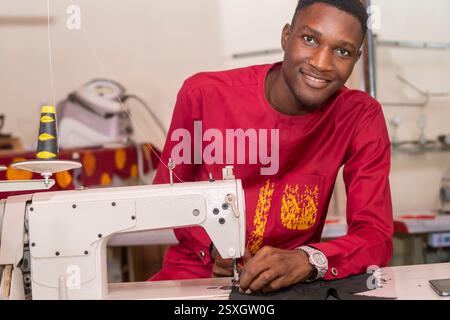male african tailor sewing with her machine Stock Photo