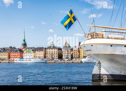 A swedish flag flies at the stern of the af Chapman sailing ship moored on the Skeppsholmen islet in Stockholm, Sweden, opposite Gamla Stan. Stock Photo