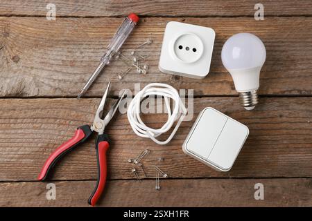 Different electrical tools on wooden table, flat lay Stock Photo