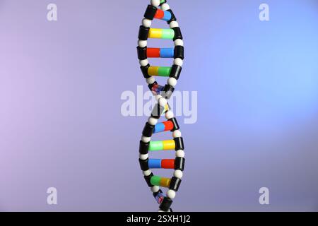 DNA structure model on color background, closeup Stock Photo