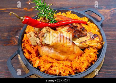 Pork knuckle served with chili pepper. This traditional dish showcases rich flavors and colors. Stock Photo
