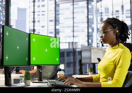 Woman working with machine learning tech on isolated screen computer, advancing AI innovating autonomous systems. IT expert in office transforming data into predictive models using chroma key PC Stock Photo