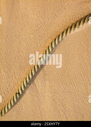 Close-up detail of rope on golden sand surface Stock Photo