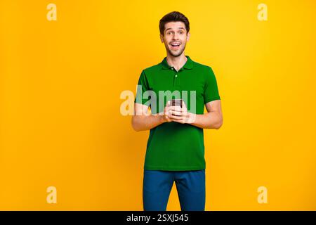 Portrait of his he nice attractive addicted delighted cheerful cheery guy wearing violet shirt using digital device modern technology isolated on Stock Photo