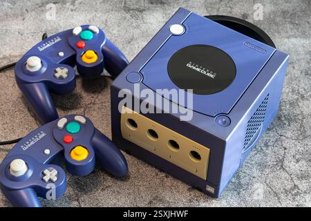 Fukuoka, Japan - january 3, 2025 : the original nintendo gamecube video game console with controllers on a concrete ground Stock Photo