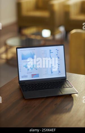 Displaying Business Analytics on Laptop at Workplace Stock Photo